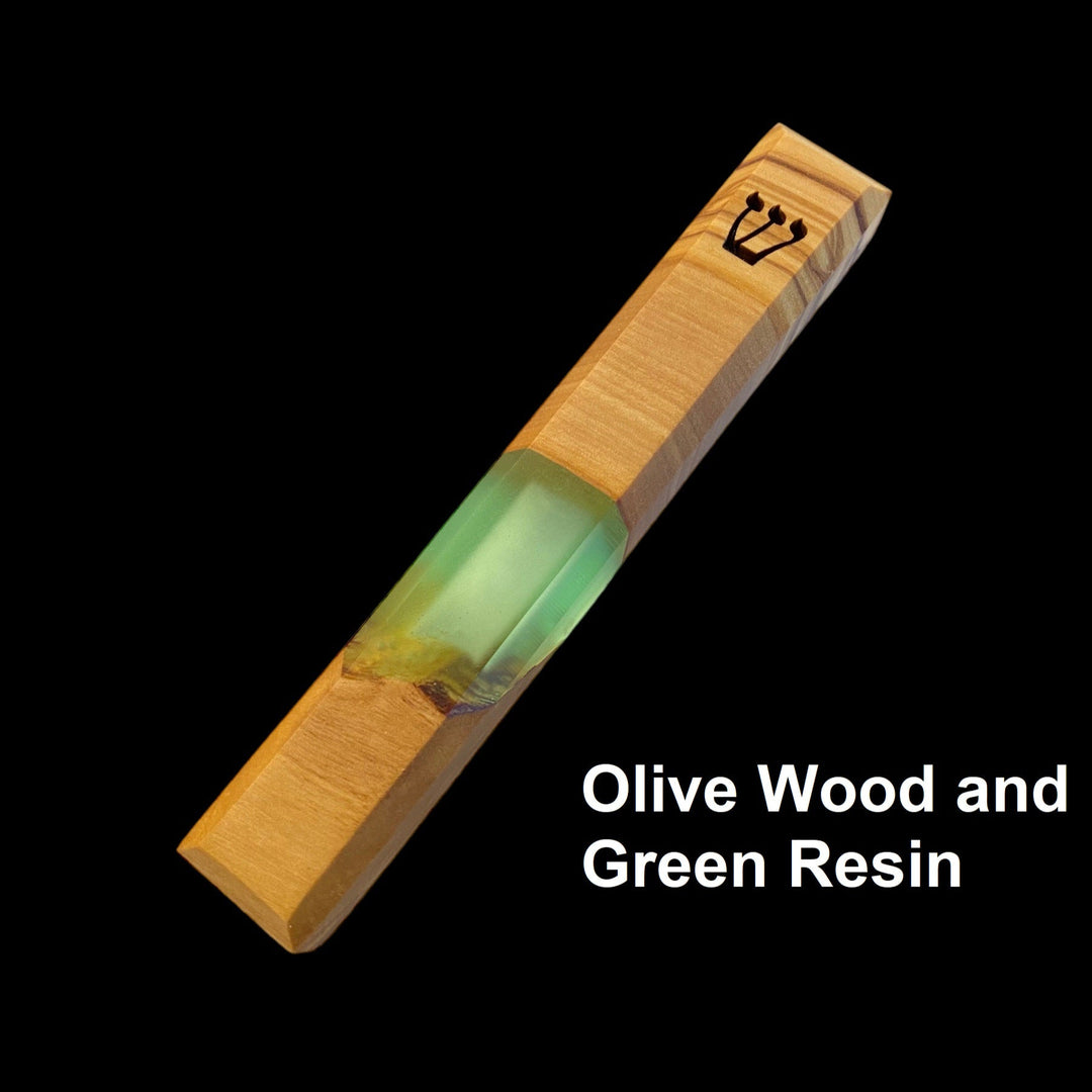 Engraved handmade olive wood and green resin mezuzah on black background