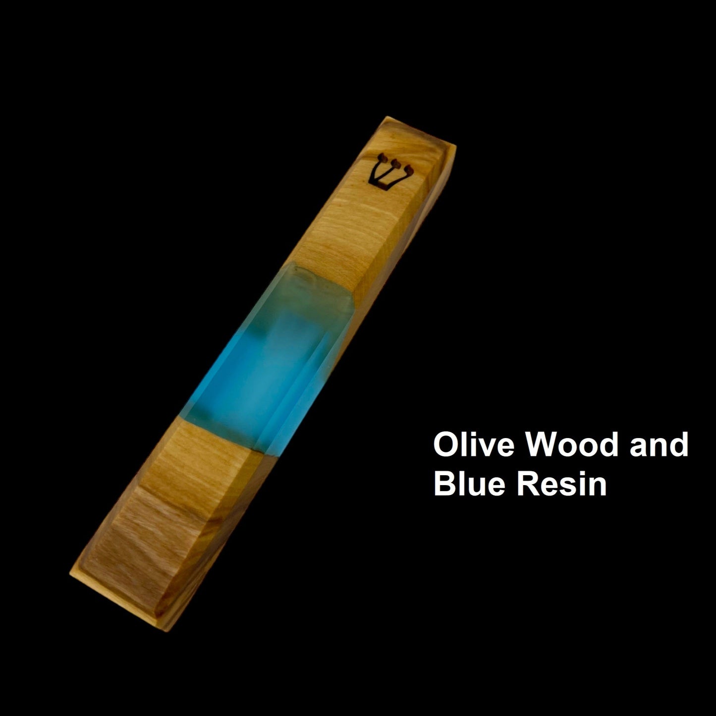 Engraved handmade olive wood and blue resin mezuzah on black background