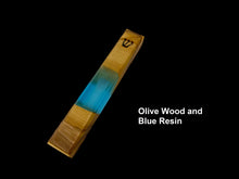 Load image into Gallery viewer, Engraved handmade olive wood and blue resin mezuzah on black background
