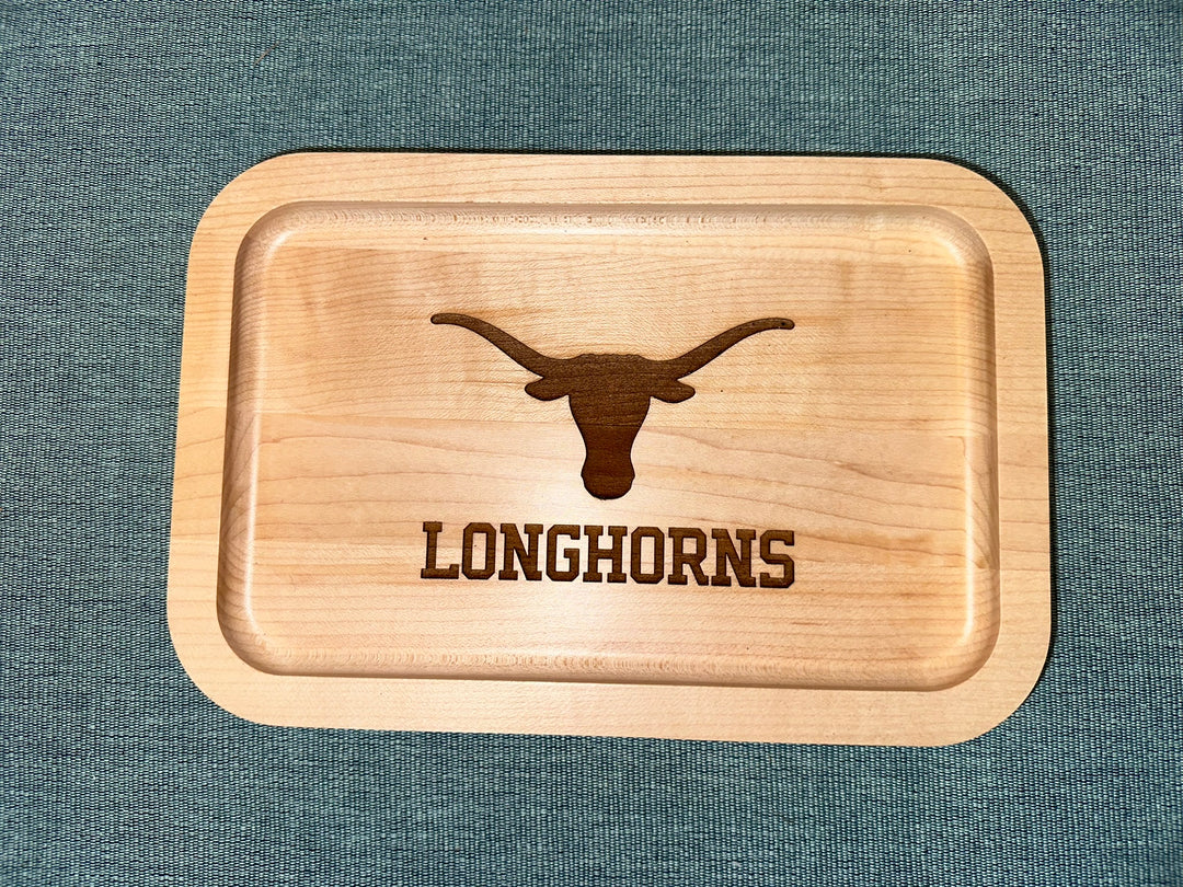 University of Texas at Austin Maple Wood Ring Tray with Outline of a Texas Longhorn skull laying on black surface