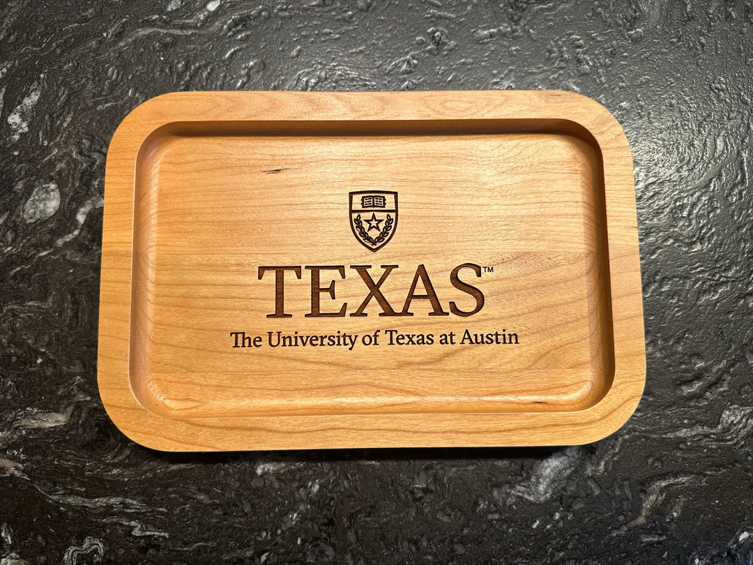 University of Texas at Austin Cherry Wood Ring Tray with University Crest  laying on black surface
