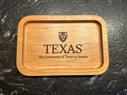 University of Texas at Austin Cherry Wood Ring Tray with University Crest  laying on black surface